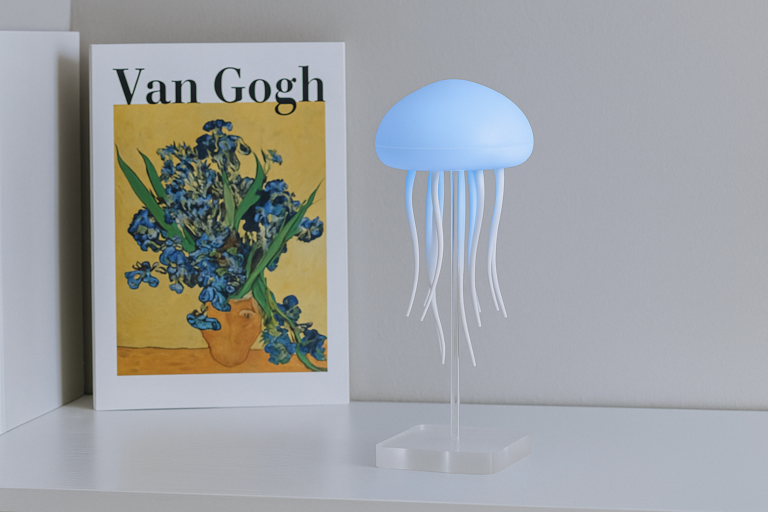 Jellyfish-shaped lamp next to a Van Gogh painting on a shelf